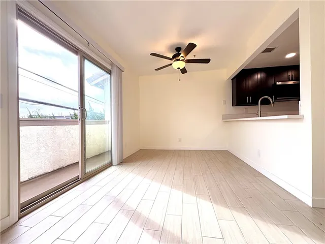 a bathroom with a granite countertop sink a toilet a mirror and bathtub