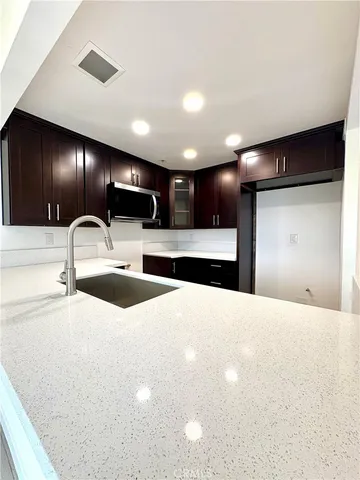 a large kitchen with a sink and cabinets