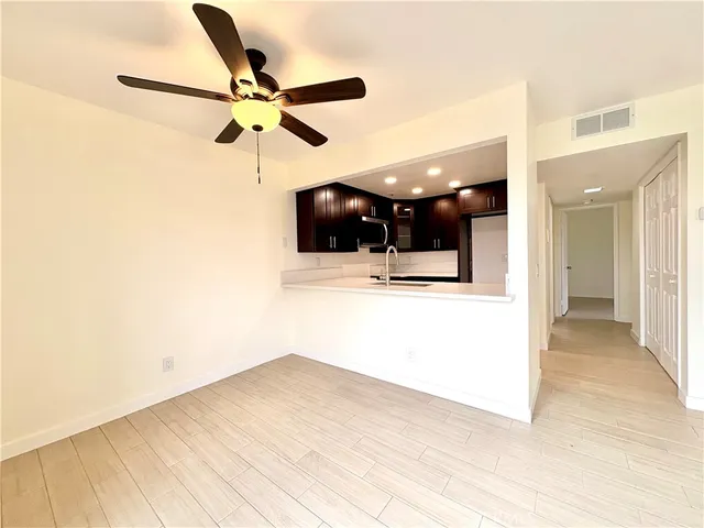 a bathroom with a granite countertop sink a toilet a mirror and bathtub