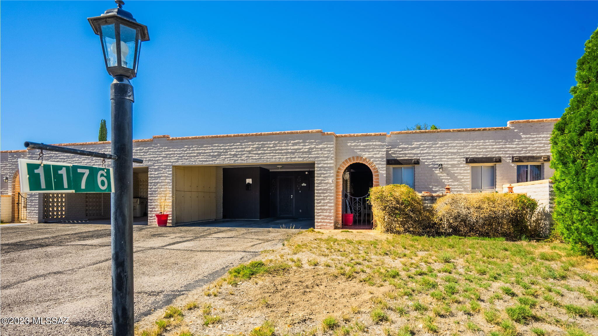 1176 Zircon Court Rio Rico, AZ 85648 - Photo 1 of 26 a front view of a house with a garden