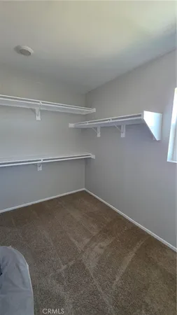 a view of an empty room and a window