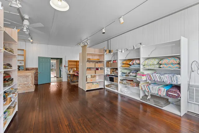 a living room with furniture and a book shelf