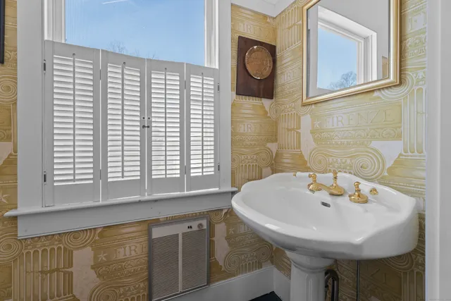 a bathroom with a sink and a window