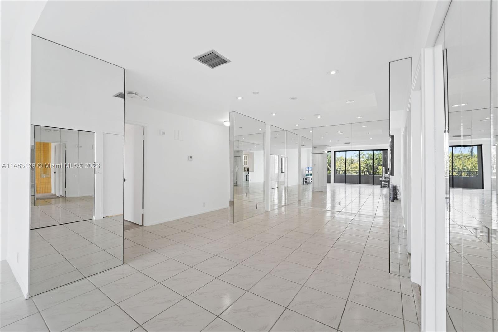 151 Crandon Boulevard, Unit 422 Key Biscayne, FL 33149 - Photo 12 of 38 a view of empty room with wooden floor and fan