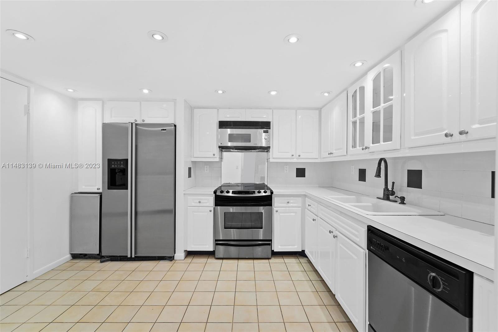 151 Crandon Boulevard, Unit 422 Key Biscayne, FL 33149 - Photo 14 of 38 a kitchen with a stove sink and refrigerator