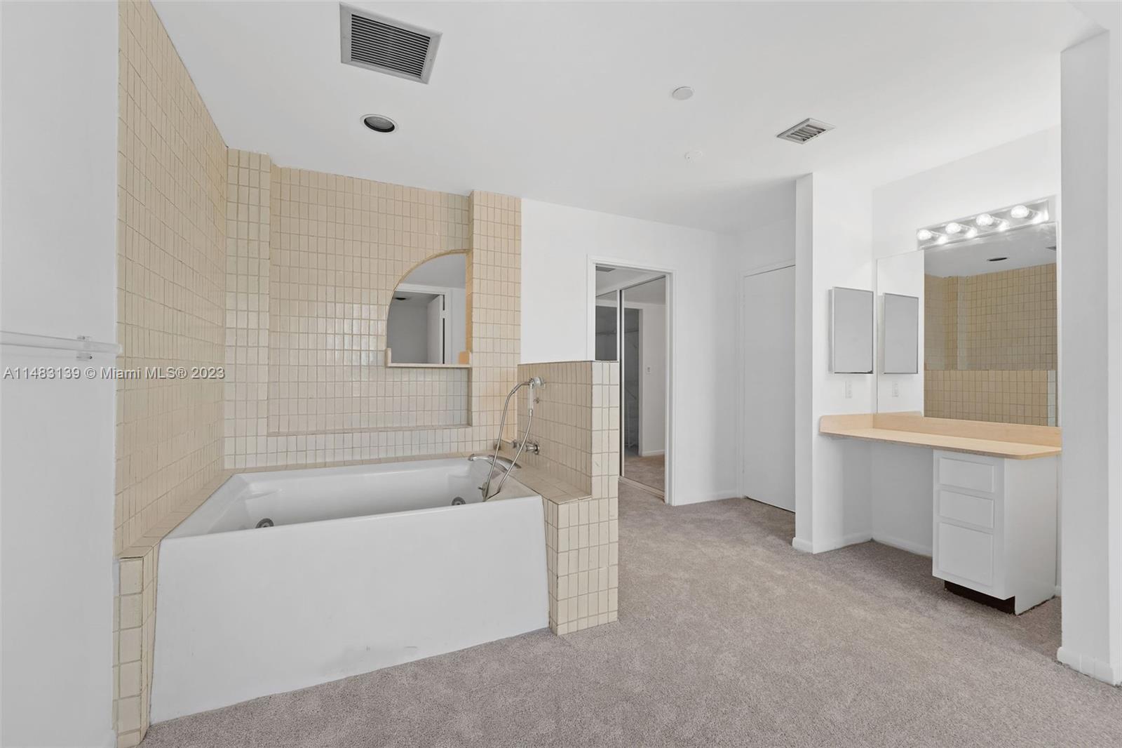 151 Crandon Boulevard, Unit 422 Key Biscayne, FL 33149 - Photo 21 of 38 a bathroom with a tub sink and mirror