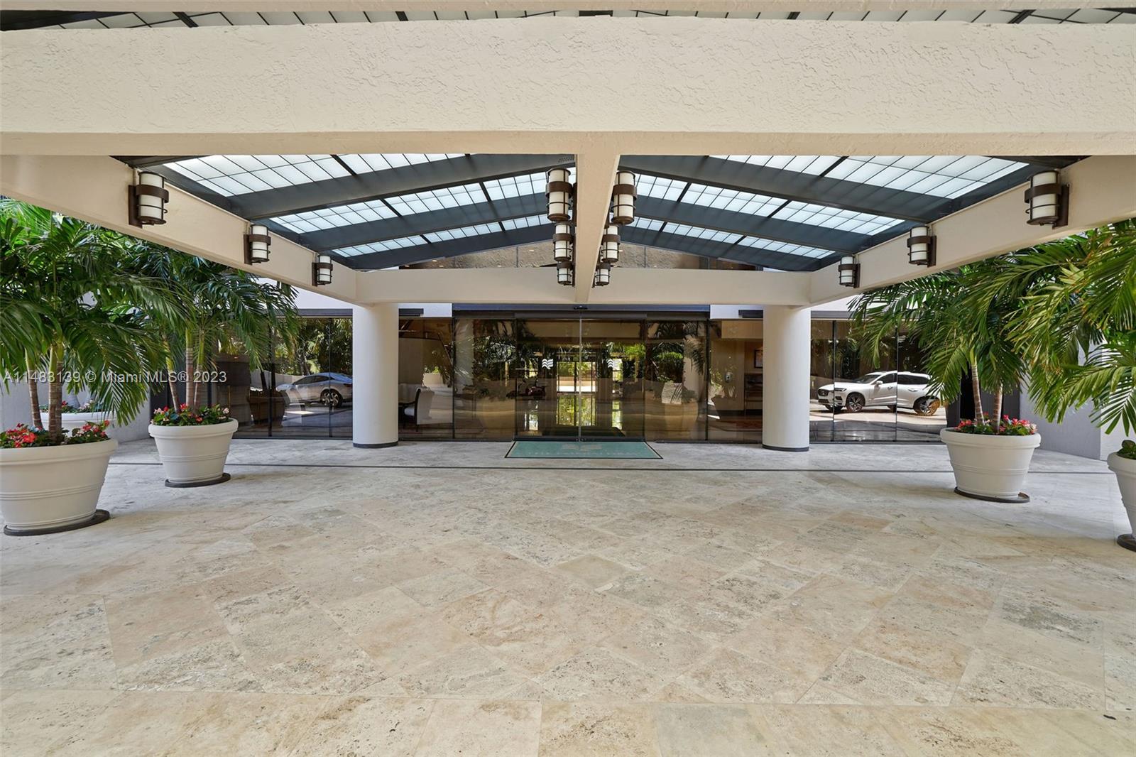 151 Crandon Boulevard, Unit 422 Key Biscayne, FL 33149 - Photo 31 of 38 a view of a patio with table and chairs potted plants