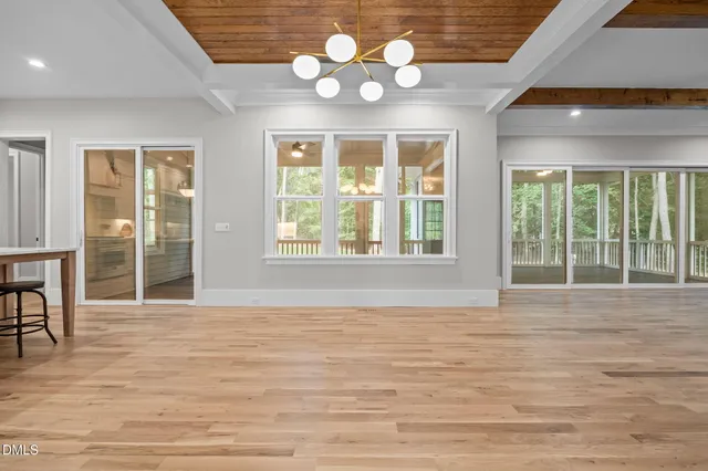 a large kitchen with stainless steel appliances kitchen island granite countertop a stove a sink and a microwave