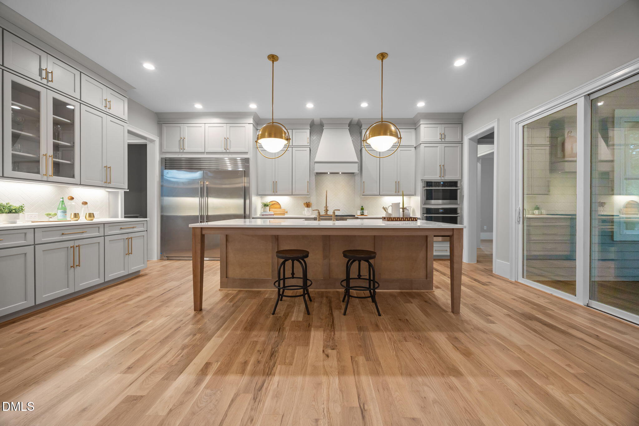 1404 Song Bird Crest Way Raleigh, NC 27613 - Photo 13 of 54 a kitchen with a table chairs sink and wooden floor