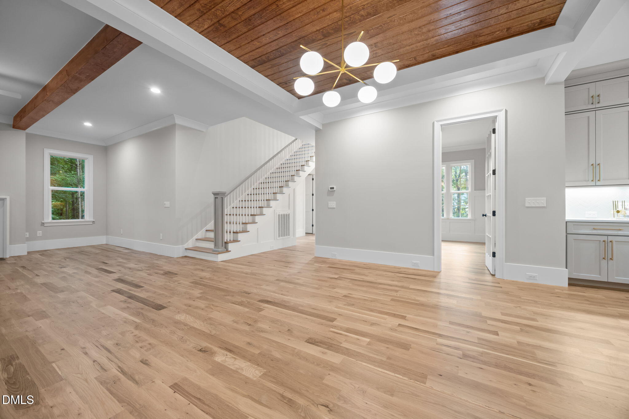 1404 Song Bird Crest Way Raleigh, NC 27613 - Photo 23 of 54 a view of an empty room with wooden floor and a large window