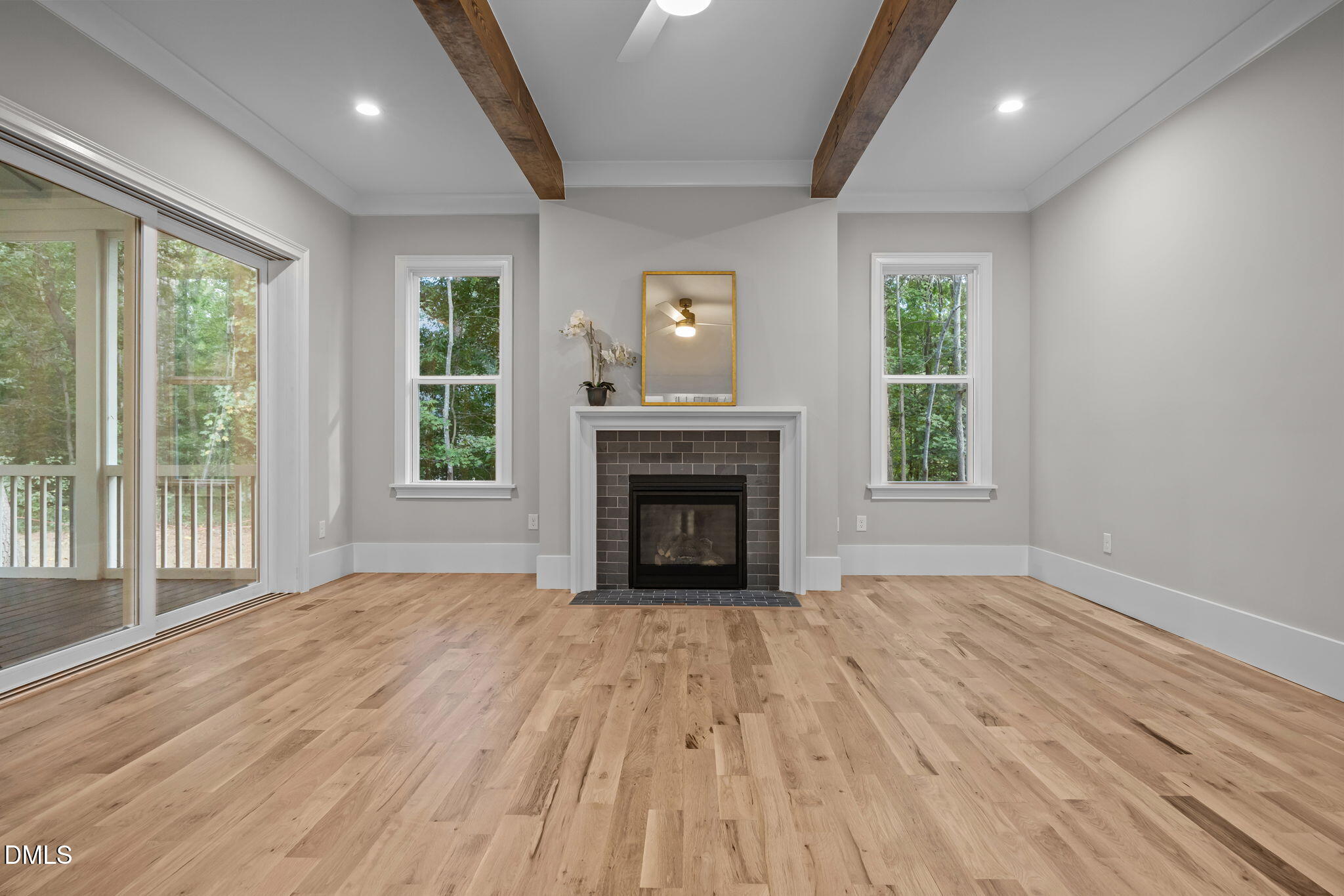 1404 Song Bird Crest Way Raleigh, NC 27613 - Photo 24 of 54 a view of empty room with wooden floor and fireplace