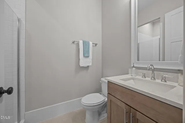 an empty room with windows and ceiling fan