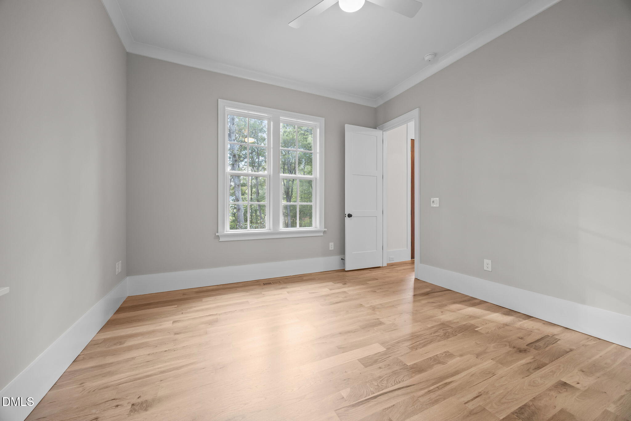1404 Song Bird Crest Way Raleigh, NC 27613 - Photo 36 of 54 wooden floor in an empty room with a window