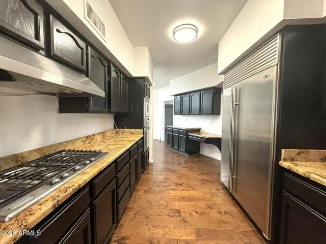 a kitchen with stainless steel appliances granite countertop a stove and a refrigerator