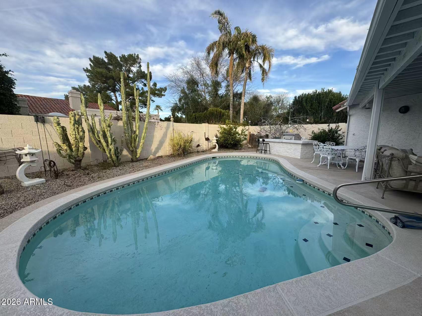 7330 East Griswold Road Scottsdale, AZ 85258 - Photo 16 of 16 a view of a swimming pool with a sitting area