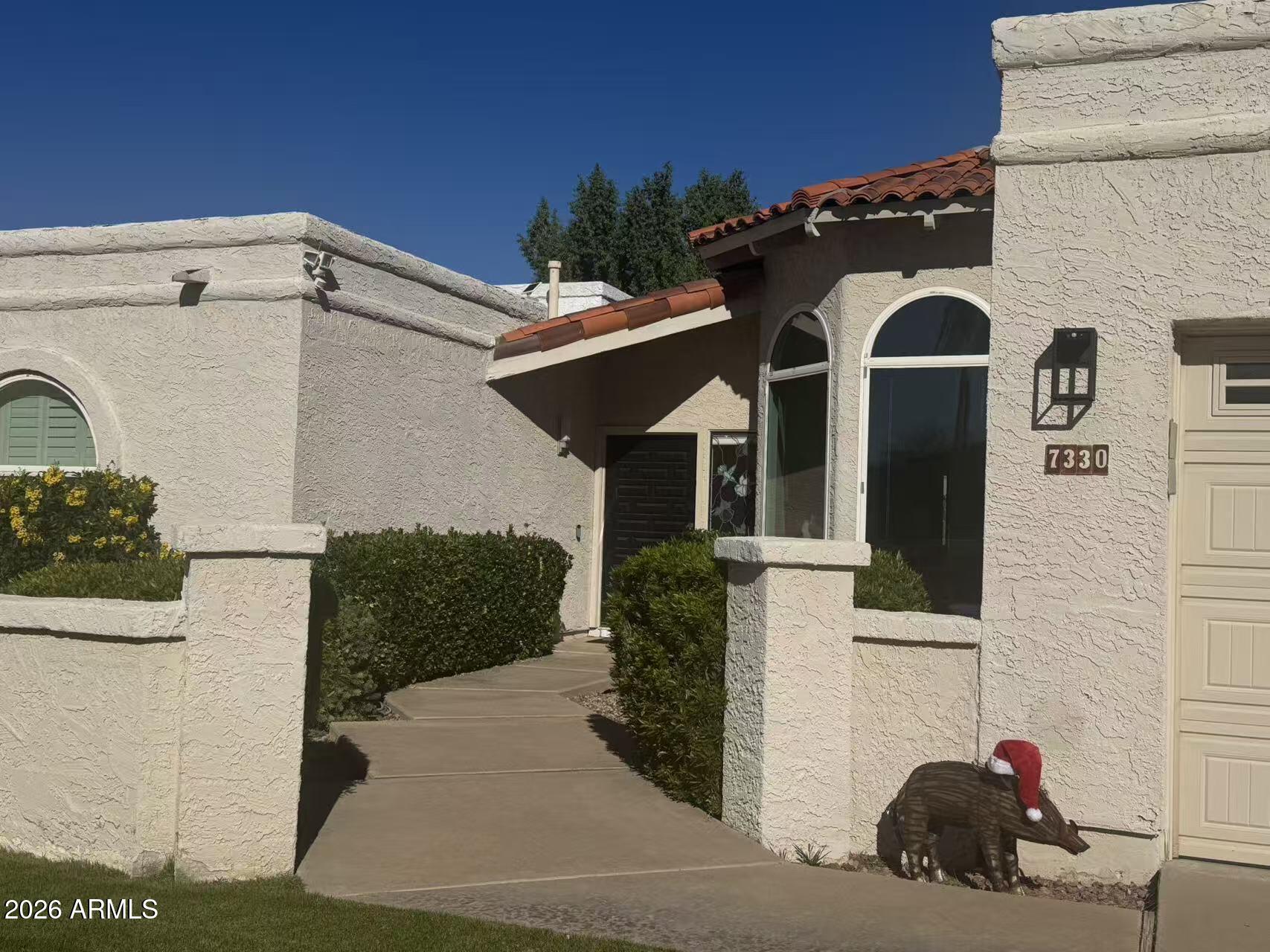 7330 East Griswold Road Scottsdale, AZ 85258 - Photo 2 of 16 a front view of a house with a yard