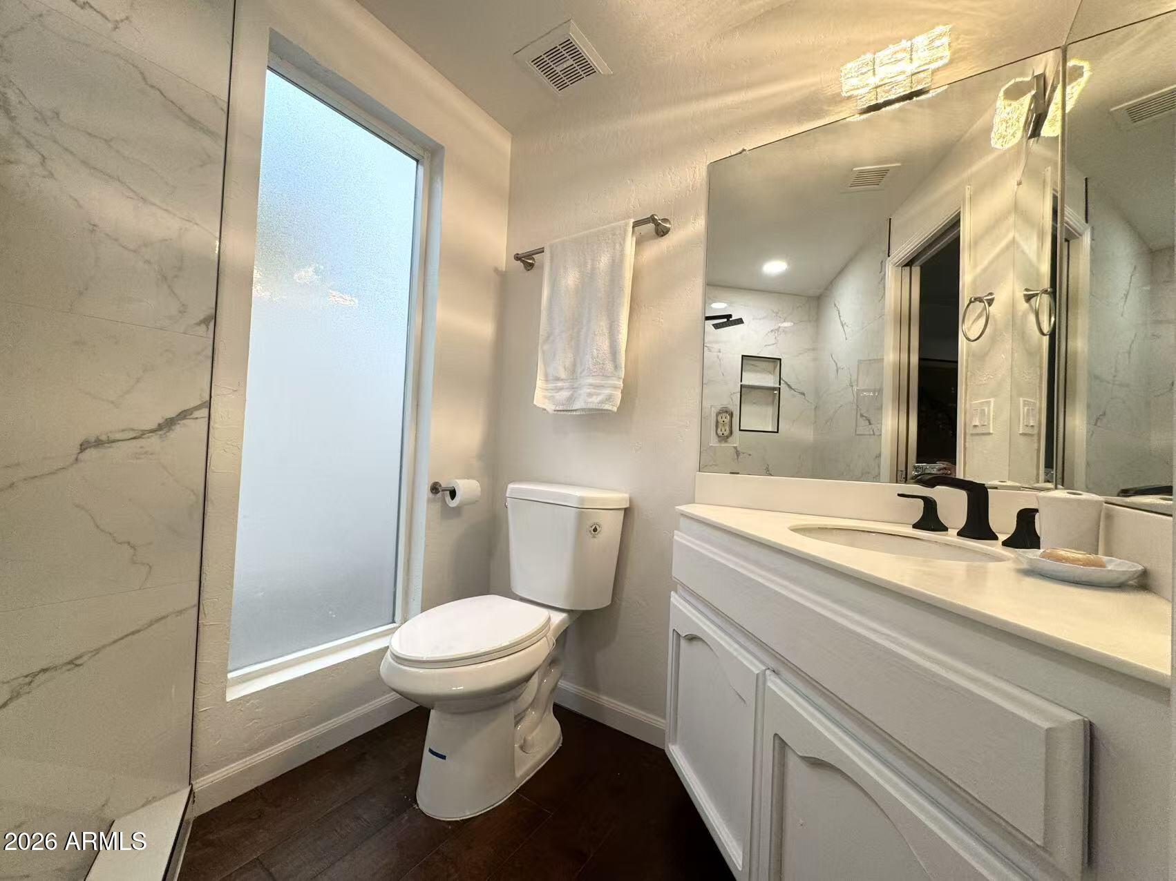 7330 East Griswold Road Scottsdale, AZ 85258 - Photo 10 of 16 a bathroom with a granite countertop sink toilet and shower