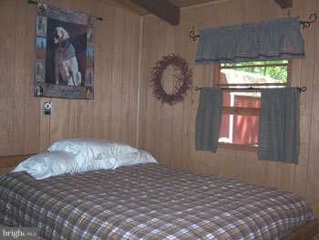 194 View Lane Augusta, WV 26704 - Photo 19 of 25 a bedroom with a bed and a window