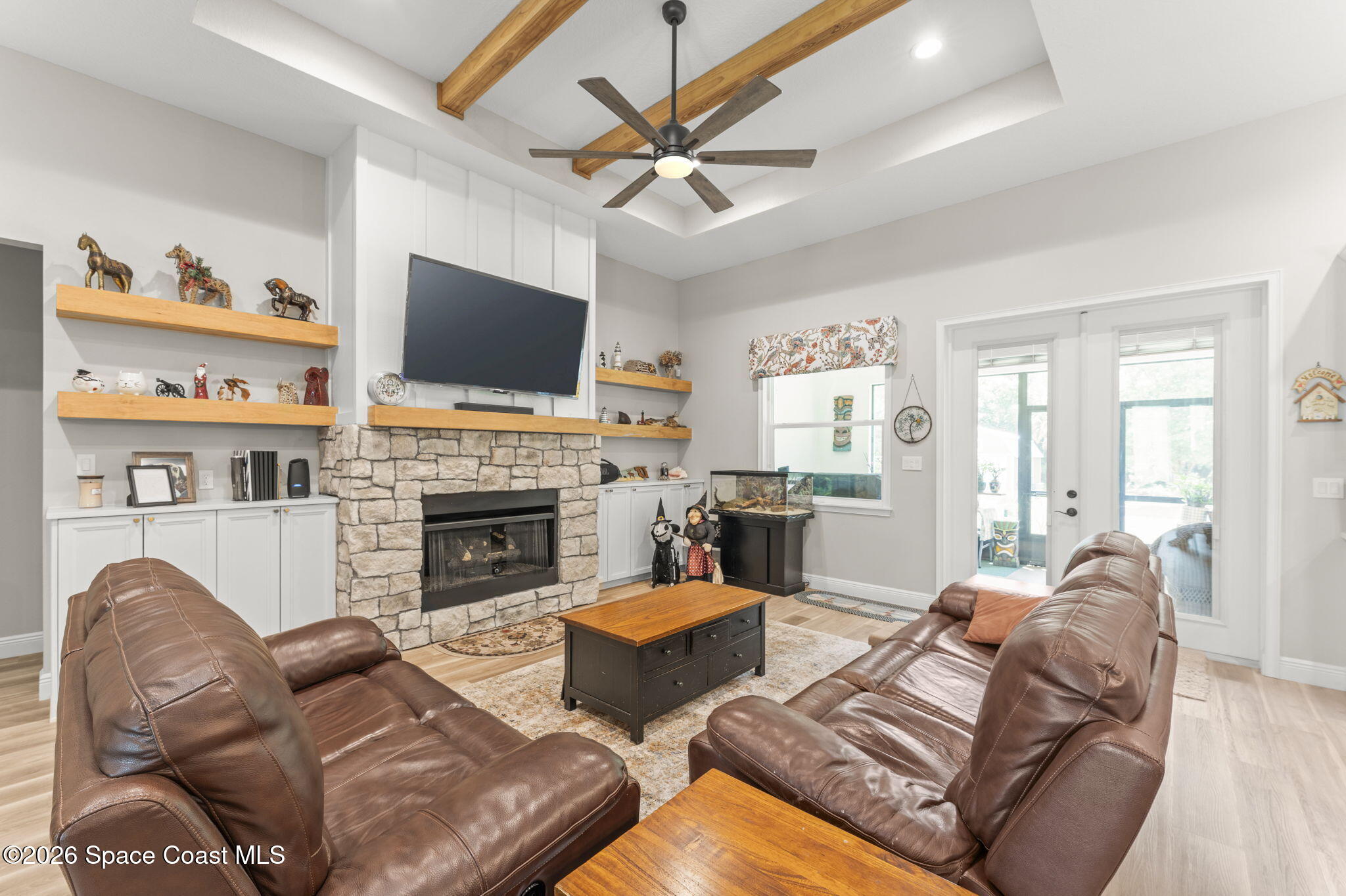 1740 Ford Road Mims, FL 32754 - Photo 11 of 43 a living room with furniture a flat screen tv and a fireplace