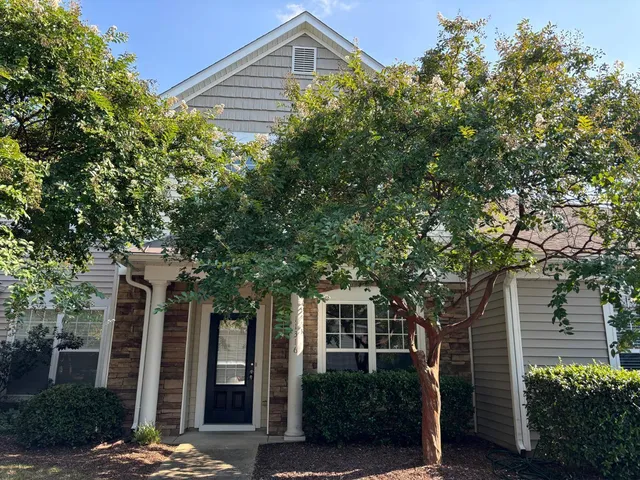 front view of a house with a tree