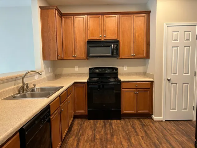 a kitchen with a sink a stove and cabinets
