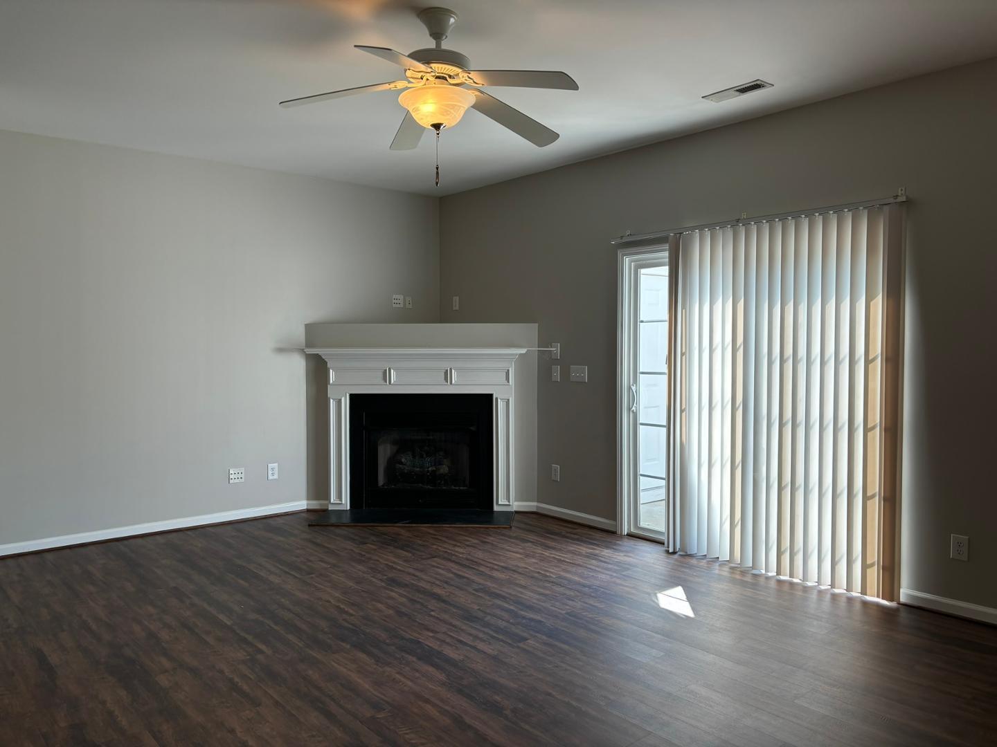 11316 Shadow Elms Lane Raleigh, NC 27614 - Photo 7 of 11 wooden floor fireplace and windows in an empty room
