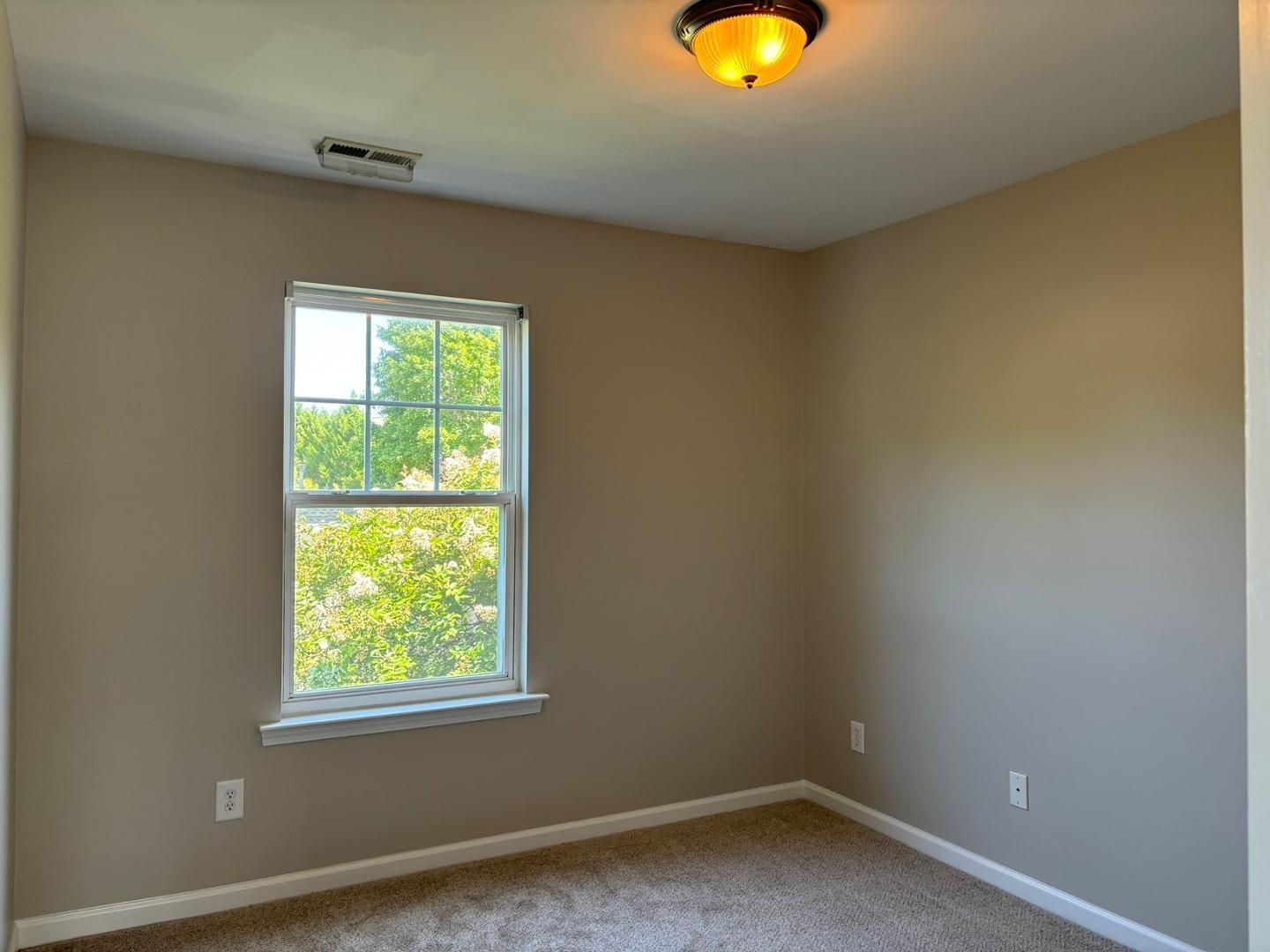 11316 Shadow Elms Lane Raleigh, NC 27614 - Photo 8 of 11 an empty room with a window