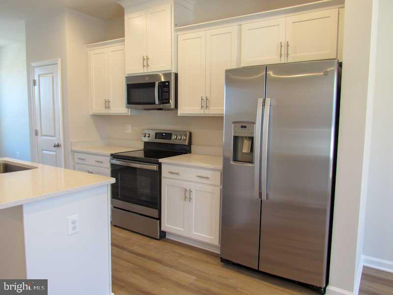 236 Anthem Street Ranson, WV 25438 - Photo 11 of 17 a kitchen with stainless steel appliances a refrigerator a stove a microwave and cabinets