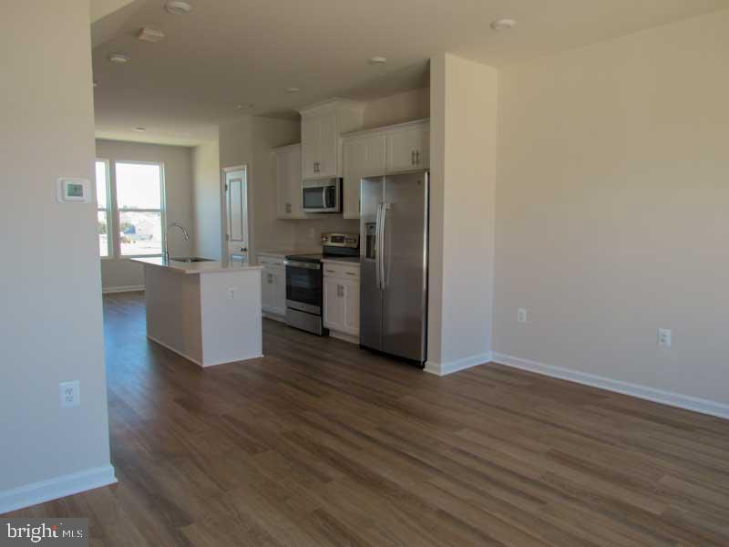 236 Anthem Street Ranson, WV 25438 - Photo 14 of 17 a kitchen with a refrigerator and a stove top oven