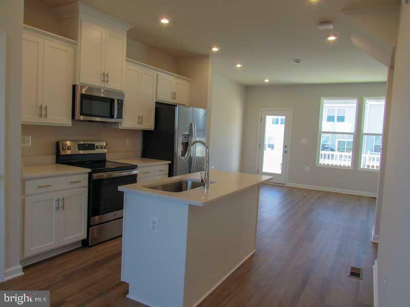 236 Anthem Street Ranson, WV 25438 - Photo 6 of 17 a kitchen with stainless steel appliances a refrigerator stove microwave and sink