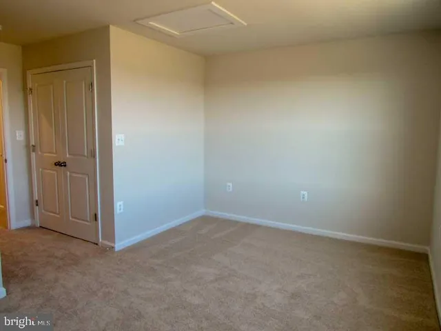 an empty room with closet area