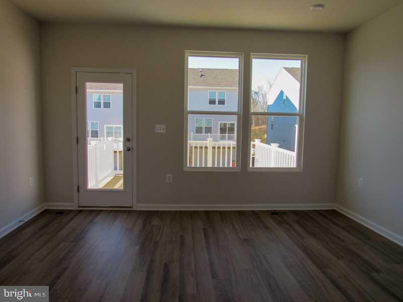 236 Anthem Street Ranson, WV 25438 - Photo 8 of 17 an empty room with wooden floor and windows