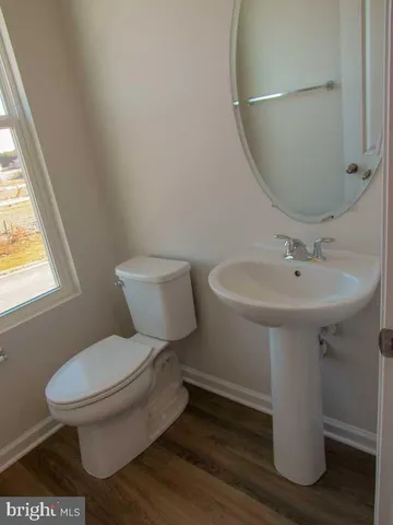 a white toilet sitting next to a bathroom sink