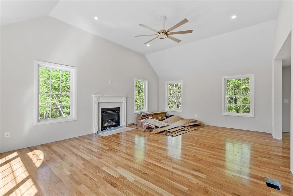 22 Benoit Avenue Pelham, NH 03076 - Photo 13 of 42 a view of a livingroom with wooden floor and a fireplace