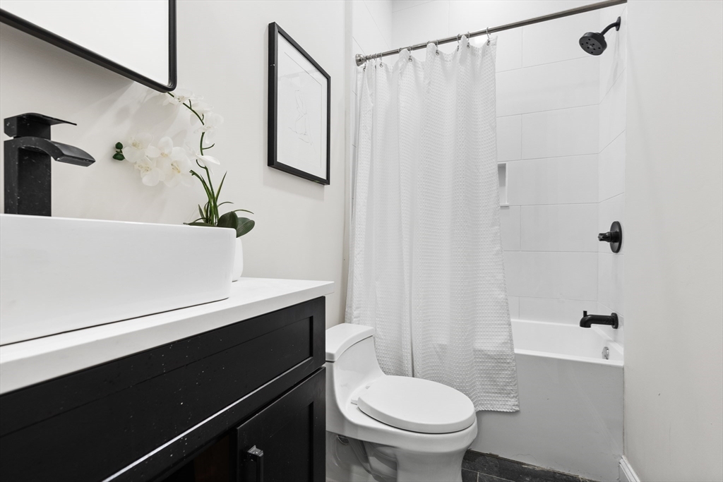 166 Salem Street, Unit A Boston, MA 02113 - Photo 16 of 16 a bathroom with a sink a toilet and shower