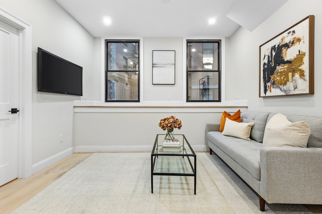 166 Salem Street, Unit A Boston, MA 02113 - Photo 2 of 16 a living room with furniture and a flat screen tv