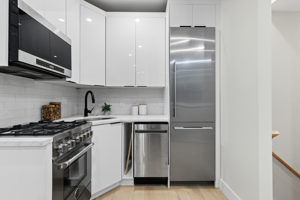 166 Salem Street, Unit A Boston, MA 02113 - Photo 6 of 16 a kitchen with stainless steel appliances granite countertop a refrigerator and a stove top oven