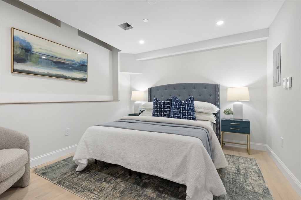 166 Salem Street, Unit A Boston, MA 02113 - Photo 8 of 16 a bedroom with a bed and a painting on the wall