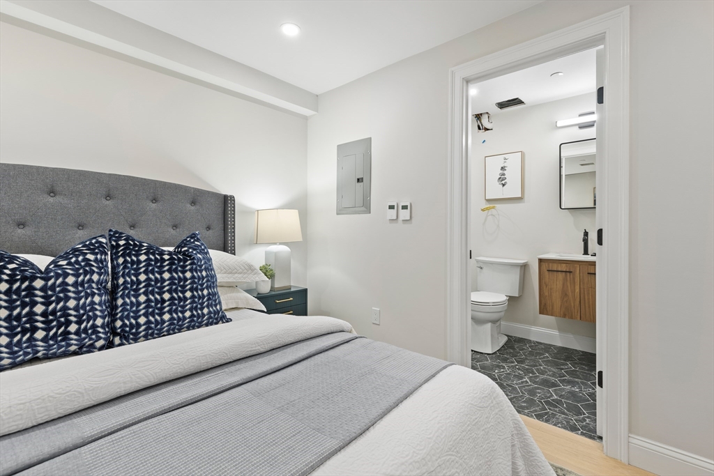 166 Salem Street, Unit A Boston, MA 02113 - Photo 9 of 16 a bedroom with a bed and a view of bathroom