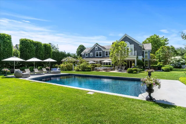 an aerial view of a house with swimming pool patio and outdoor seating