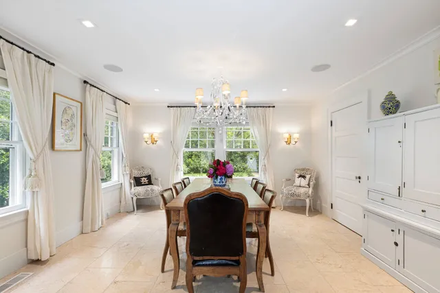 a view of a dining room with furniture and chandelier