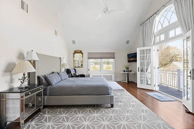 a bedroom with a large bed and a window