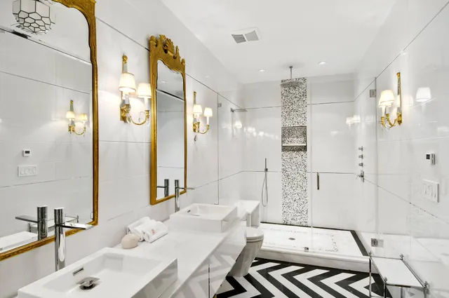 a bathroom with a double vanity sink mirror and shower