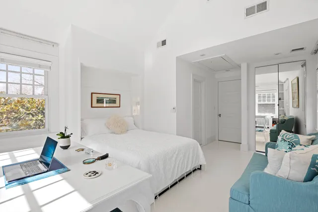 a bedroom with a bed and a table