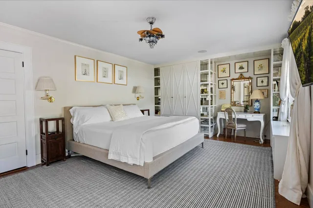 a bedroom with a large bed and a chandelier