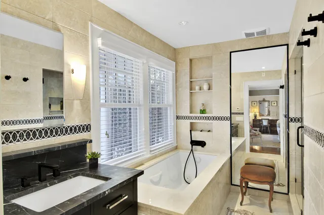 a view of a livingroom with furniture a fireplace and windows