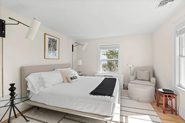 a bedroom with a large bed and a couch