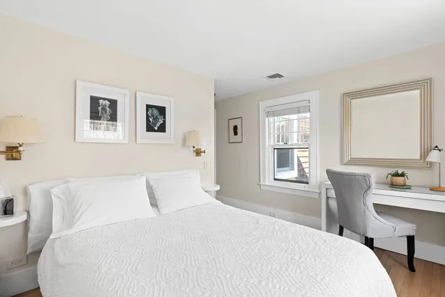 a bedroom with a large bed and a window