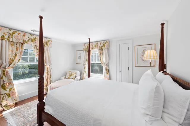 a bedroom with a large window and a bed