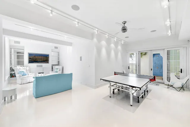 a room with furniture a flat screen tv and a view of bathroom